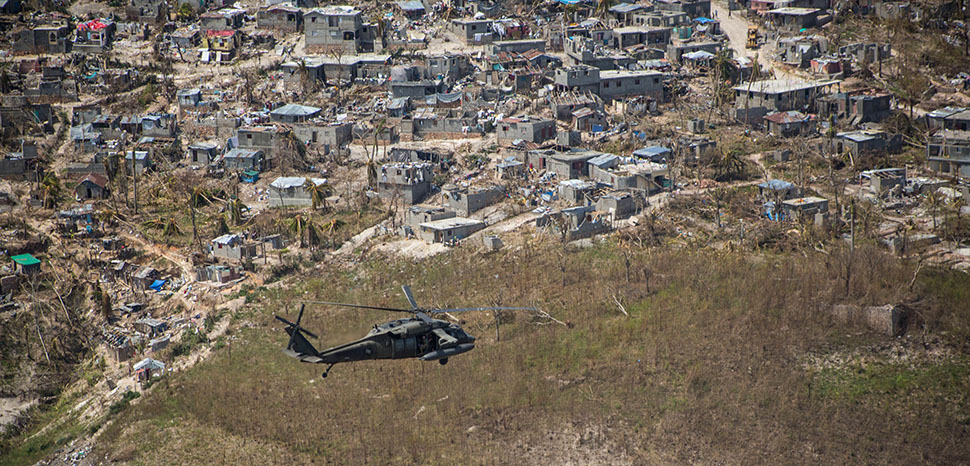 cc Cpl. Kimberly Aguirre , modified, An Army UH-60 Black Hawk helicopter flies toward a supply distribution point in Jeremie, Haiti, Oct. 10, 2016. The helicopter crew is assigned to Joint Task Force Bravo’s 1st Battalion, 228th Aviation Regiment, and deployed in support of Joint Task Force Matthew. Marine Corps photo by Cpl. Kimberly Aguirre; https://www.defense.gov/Multimedia/Photos/igphoto/2001646294/mediaid/1490723/