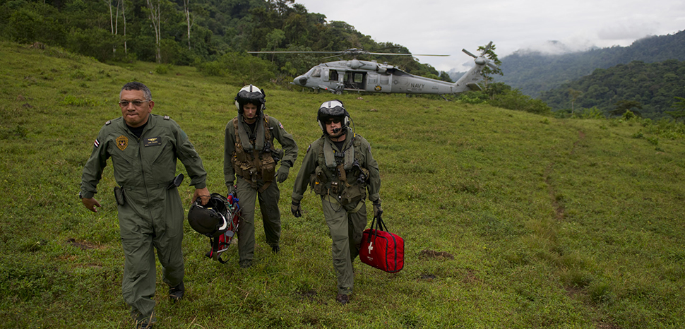 110810-N-RM525-443 BAJO BLAY, Costa Rica (Aug. 10, 2011) Costa Rica Police Air Patrol Officer Capt. George Lozano, left, Naval Air Crewman 3rd Class Joe Wainscott and Chief Naval Air Crewman Justin Crowe head toward a village to assist an injured boy in Bajo, Blay, Costa Rica, during Continuing Promise 2011. Continuing Promise is a five-month humanitarian assistance mission to the Caribbean, Central and South America. (U.S. Navy photo by Mass Communication Specialist 2nd Class Jonathen E. Davis/Released)