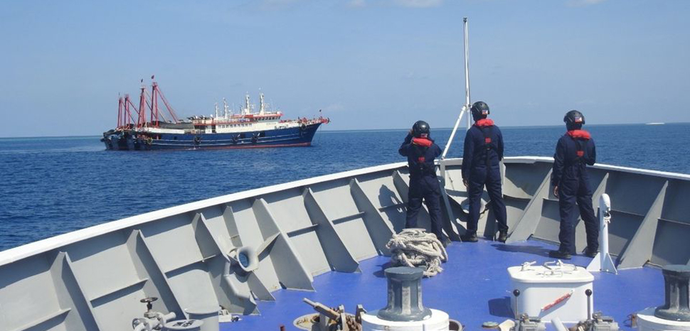 Philippine Coast Guard personnel survey several ships believed to be Chinese militia vessels in Sabina Shoal in the South China Sea, in a handout photo distributed by the Philippine Coast Guard on 5 May and taken according to source on 27 April 2021., modified, Philippines Coast Guard, https://commons.wikimedia.org/w/index.php?sort=last_edit_desc&search=china+maritime+militia+filetype%3Abitmap&title=Special%3ASearch&profile=advanced&fulltext=1&advancedSearch-current=%7B%22fields%22%3A%7B%22filetype%22%3A%22bitmap%22%7D%7D&ns0=1&ns6=1&ns12=1&ns14=1&ns100=1&ns106=1#/media/File:Philippine_coast_guard-COFTLDK4CRL5LFGQLAVIYGDEQE.jpg